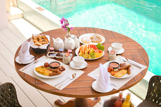 Luxury breakfast by the pool with tropical fruits